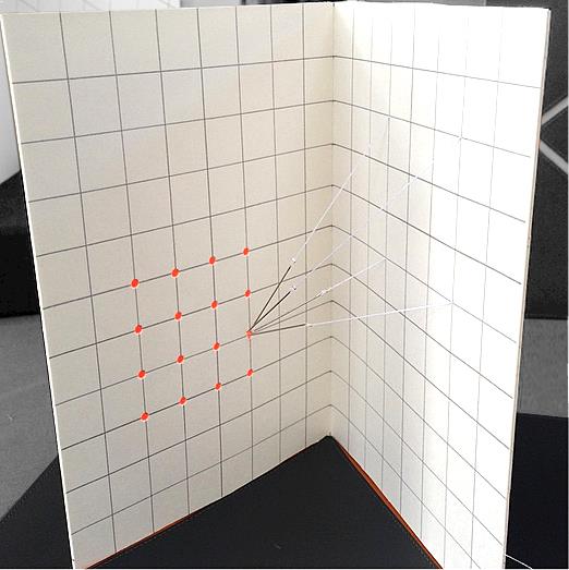 Artists book by Karen Bleitz entitled 78-62 Degrees. Needles suspended by thread pull towards the opposite page.