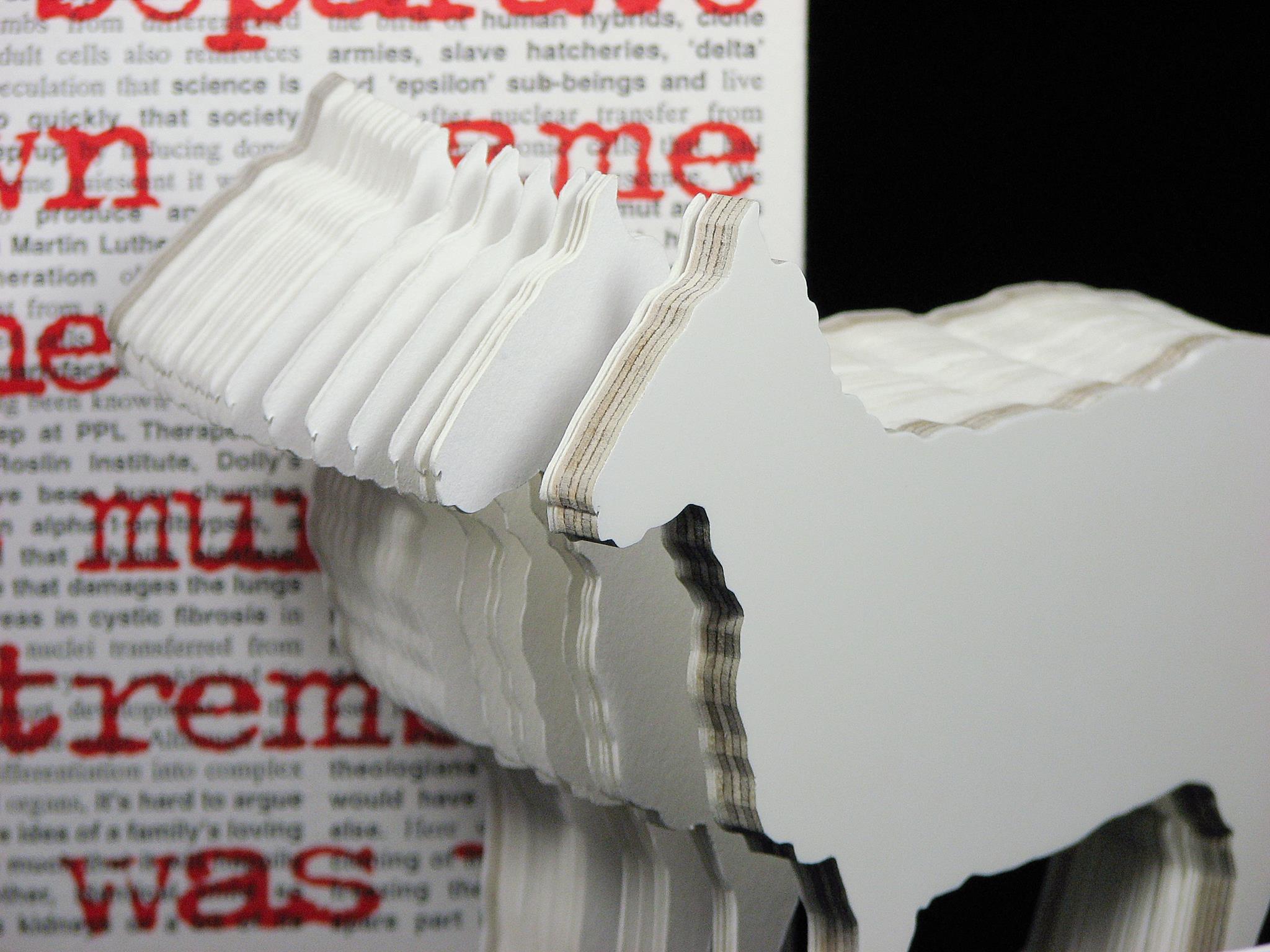 Close up view of artist book Dolly: Edition Unlimited by Karen Bleitz, a pop-out jig-sawed book-work on the theme of the cloned sheep, Dolly, with a freestanding herd of sheep integrated into the form of the book.